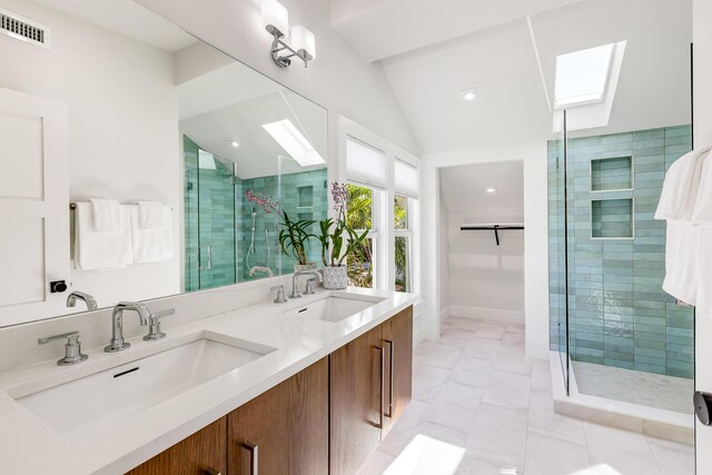 1114 Grinnell St, Key West, FL 33040 - full bathroom featuring a skylight, vaulted ceiling, a stall shower, double vanity, and a spacious closet