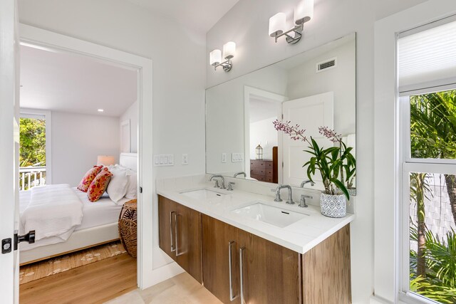 1114 Grinnell St, Key West, FL 33040 - bathroom featuring connected bathroom, healthy amount of natural light, double vanity, and wood finished floors