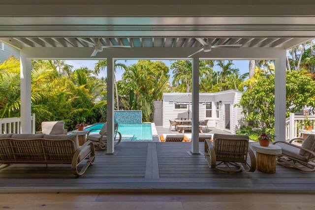 1114 Grinnell St, Key West, FL 33040 - wooden terrace with an outdoor living space, an outdoor pool, and an outbuilding