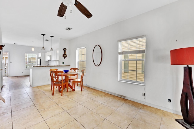 dining room with light tile patterned flooring and ceiling fan