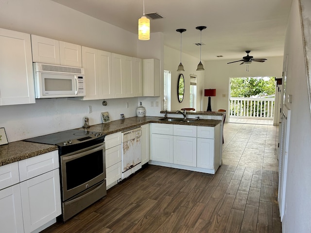 kitchen featuring sink, white appliances, white cabinetry, hanging light fixtures, and kitchen peninsula