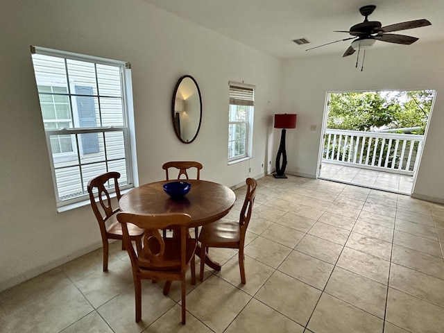 tiled dining space with ceiling fan