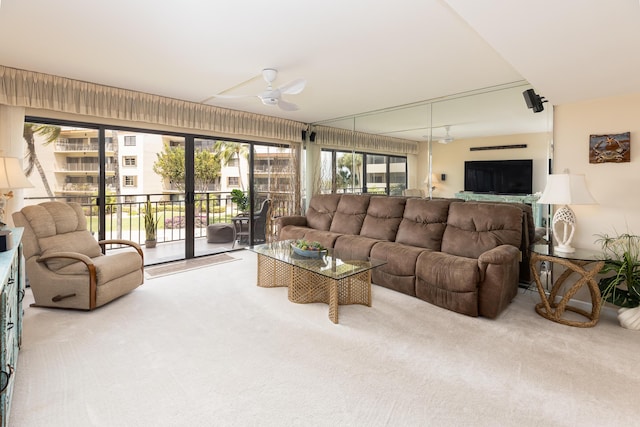 living room with ceiling fan and carpet