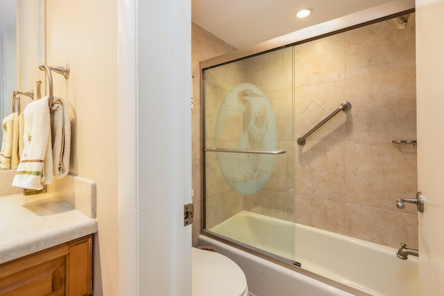 full bathroom featuring toilet, vanity, and bath / shower combo with glass door