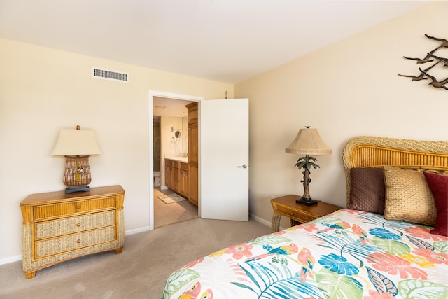 carpeted bedroom with connected bathroom