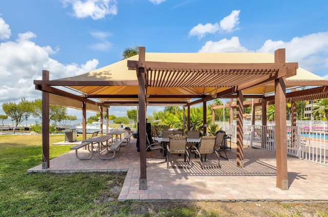 view of property's community featuring a pergola, a yard, and a patio area