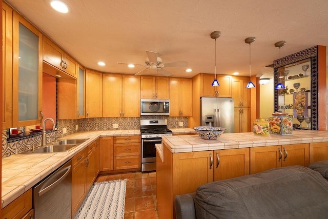 1617 Jamaica Dr, Key West, FL 33040 - kitchen with appliances with stainless steel finishes, tile counters, sink, and backsplash