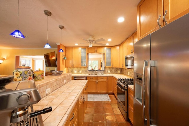 1617 Jamaica Dr, Key West, FL 33040 - kitchen with sink, backsplash, hanging light fixtures, stainless steel appliances, and tile countertops