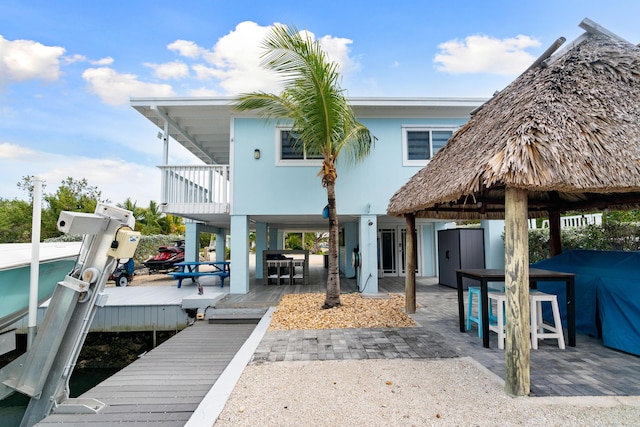 66 Seagate Blvd, Key Largo, FL 33037 - rear view of house with a patio, a balcony, and boat lift