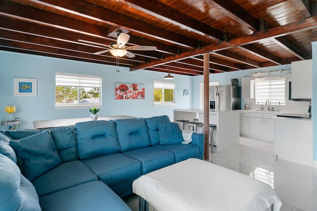 66 Seagate Blvd, Key Largo, FL 33037 - living area with wood ceiling with exposed beams, a ceiling fan, plenty of natural light, and light tile patterned flooring