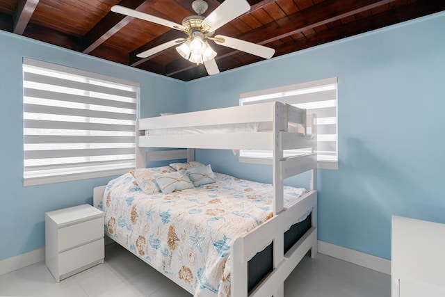 66 Seagate Blvd, Key Largo, FL 33037 - tiled bedroom featuring wood ceiling with exposed beams and baseboards