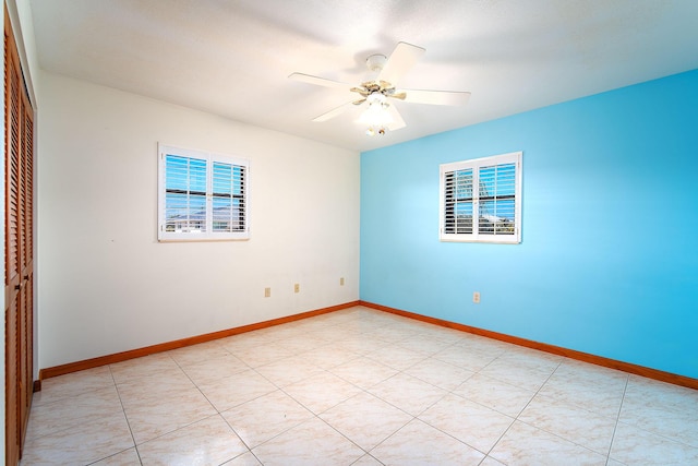 unfurnished room with ceiling fan