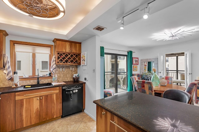 kitchen featuring a sink, brown cabinets, decorative backsplash, and dishwasher