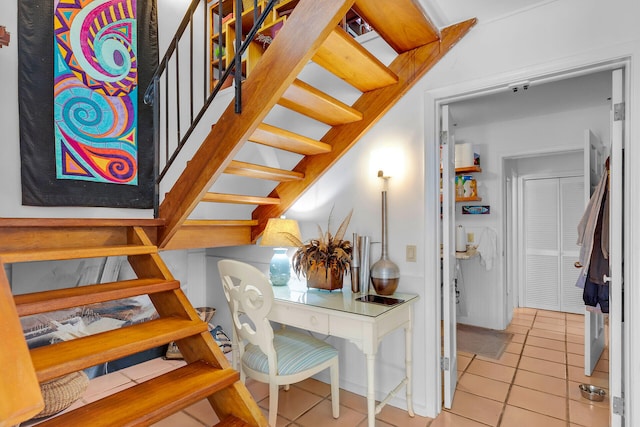 staircase featuring tile patterned flooring