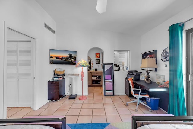 home office with arched walkways, visible vents, and light tile patterned floors