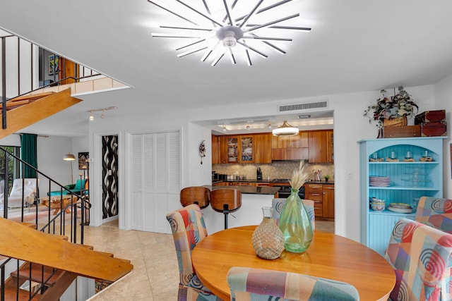 dining space with an inviting chandelier, stairs, visible vents, and light tile patterned floors