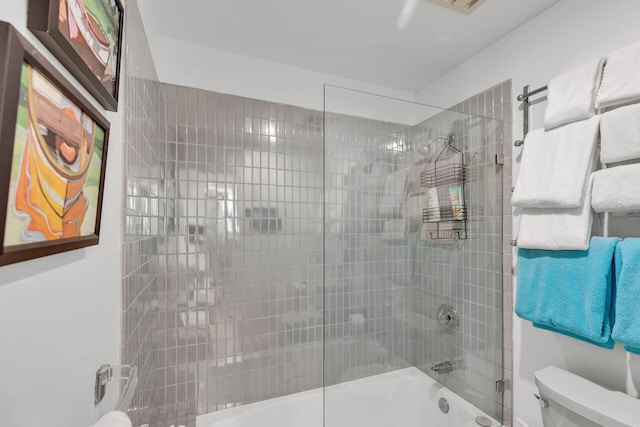 bathroom with tub / shower combination and toilet