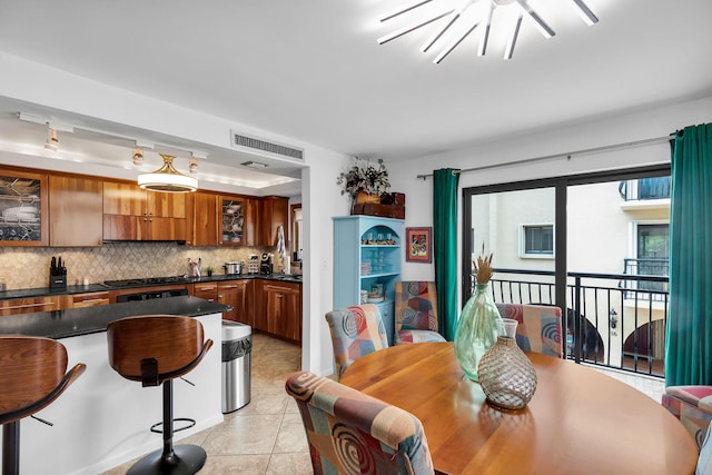 dining area featuring light tile patterned floors and visible vents