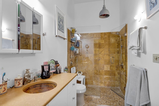 full bath featuring a stall shower, vanity, and toilet