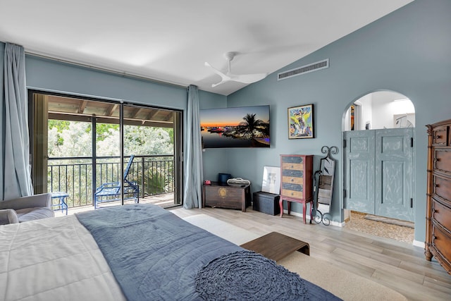 bedroom featuring arched walkways, wood finished floors, visible vents, access to exterior, and vaulted ceiling