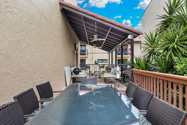 deck featuring ceiling fan and an outdoor living space