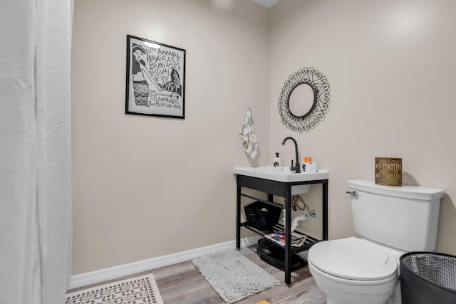 102 Sands Ln, Layton, FL 33001 - bathroom featuring wood finished floors, toilet, and baseboards
