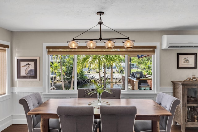 102 Sands Ln, Layton, FL 33001 - dining area featuring an AC wall unit, wood finished floors, healthy amount of natural light, a wainscoted wall, and a chandelier