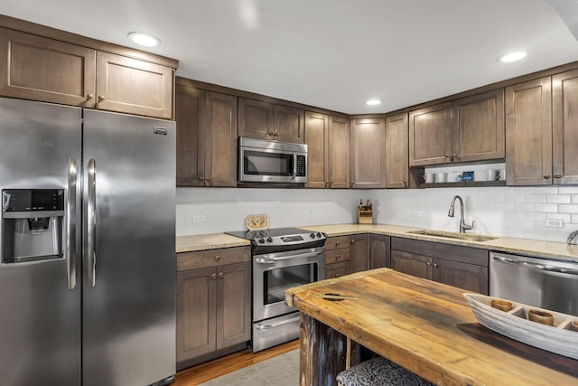 102 Sands Ln, Layton, FL 33001 - kitchen with stainless steel appliances, a sink, tasteful backsplash, wooden counters, and recessed lighting