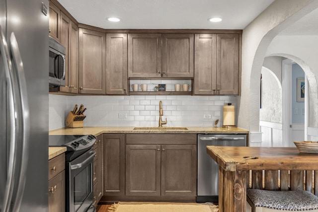 102 Sands Ln, Layton, FL 33001 - kitchen featuring appliances with stainless steel finishes, a sink, butcher block counters, backsplash, and wainscoting
