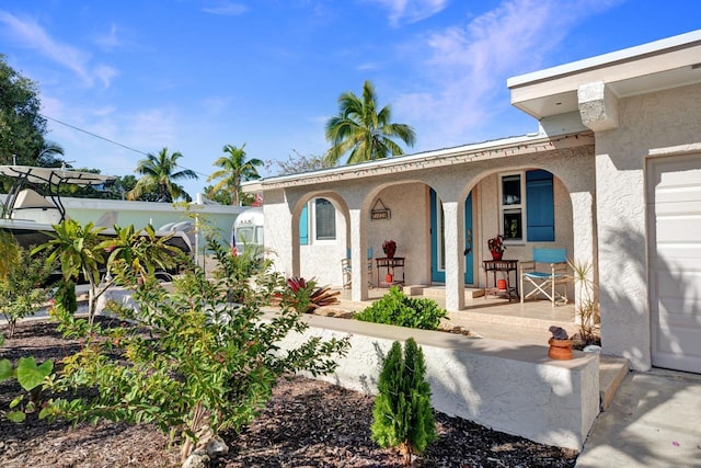 102 Sands Ln, Layton, FL 33001 - view of front of property with covered porch and stucco siding