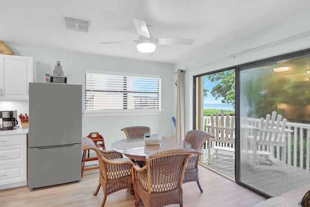 dining room featuring ceiling fan, plenty of natural light, and light hardwood / wood-style flooring