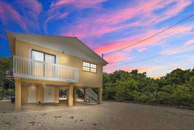 view of front facade with stairs, central AC, and a carport