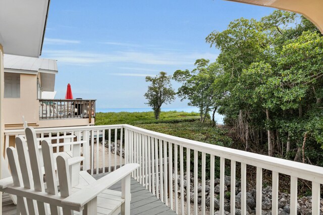 wooden deck with a water view and grilling area