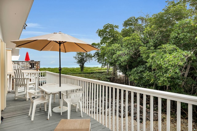 wooden deck featuring outdoor dining space