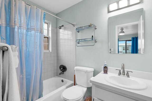 full bathroom with toilet, vanity, a wealth of natural light, and shower / bath combo