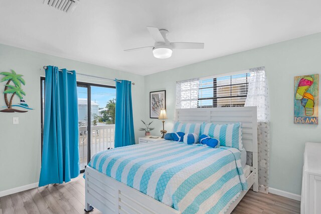 bedroom featuring ceiling fan, light hardwood / wood-style flooring, and access to outside