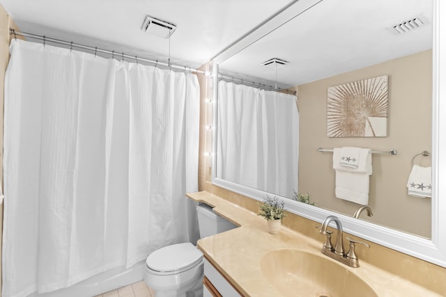 bathroom featuring vanity, tile patterned floors, toilet, and walk in shower