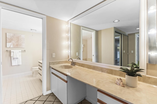 bathroom with vanity, tile patterned flooring, and toilet