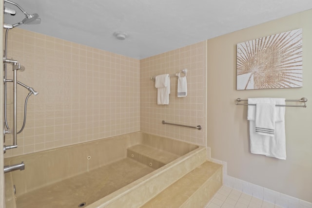 bathroom featuring tile patterned flooring and a tile shower