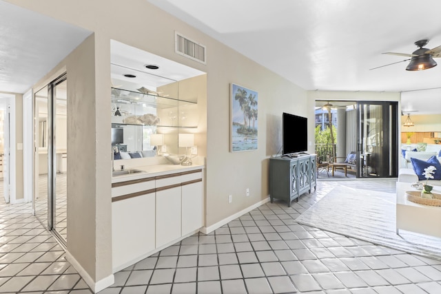 interior space featuring white cabinets and ceiling fan