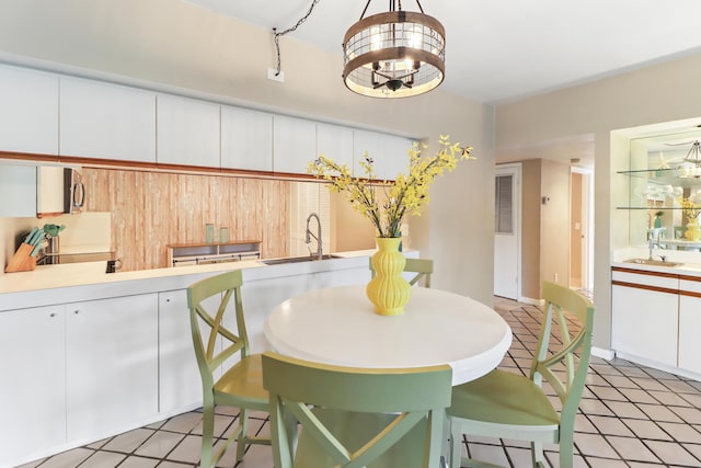 dining room with sink and a chandelier