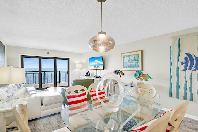 1001 W Ocean Dr Unit 1-305, Key Colony, FL 33051 - dining area with a textured ceiling and light wood-style flooring