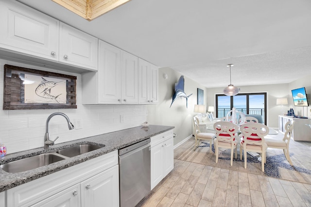 1001 W Ocean Dr Unit 1-305, Key Colony, FL 33051 - kitchen featuring dishwasher, tasteful backsplash, light wood finished floors, white cabinets, and dark stone countertops