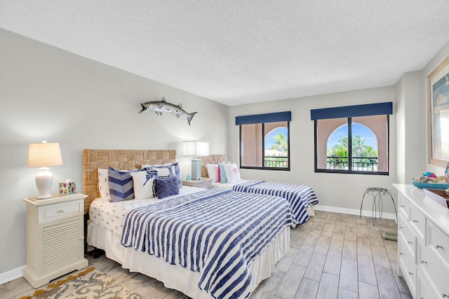 1001 W Ocean Dr Unit 1-305, Key Colony, FL 33051 - bedroom with light wood-type flooring and a textured ceiling
