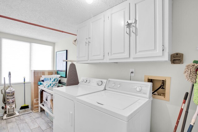 1001 W Ocean Dr Unit 1-305, Key Colony, FL 33051 - laundry room with cabinet space, washing machine and dryer, and a textured ceiling