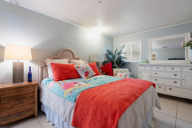 bedroom with light tile patterned floors and a textured ceiling