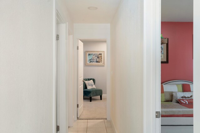 hall with light tile patterned floors