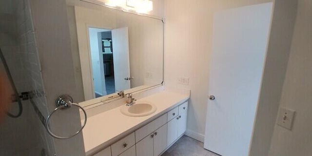 bathroom with walk in shower and vanity