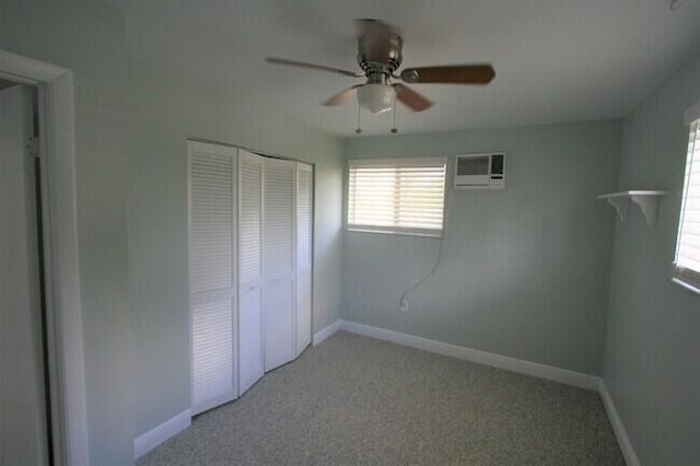 unfurnished bedroom featuring ceiling fan, light colored carpet, a wall mounted air conditioner, and a closet