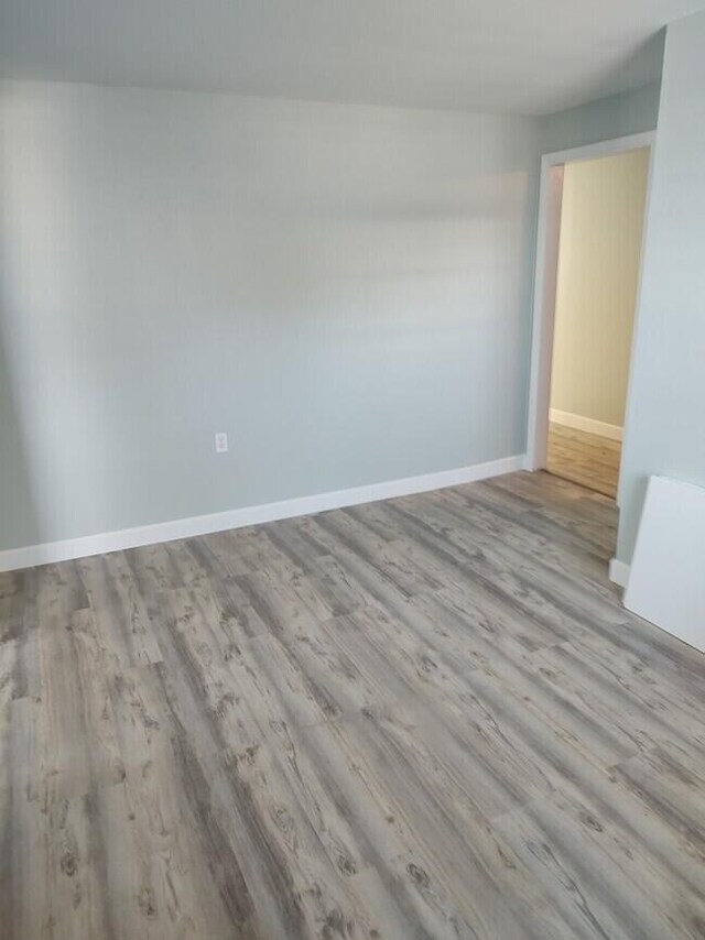 unfurnished room with light hardwood / wood-style flooring